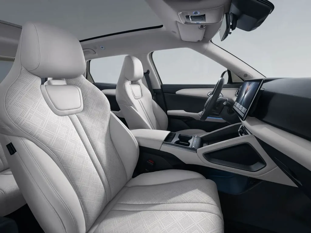 BYD Yuan Up interior front cabin view with white leather seats, panoramic sunroof, and large central touchscreen display in compact electric SUV
