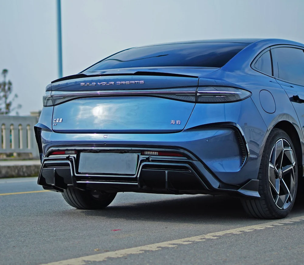 Marvix gloss black rear diffuser installed on a blue BYD Seal, rear three-quarter view