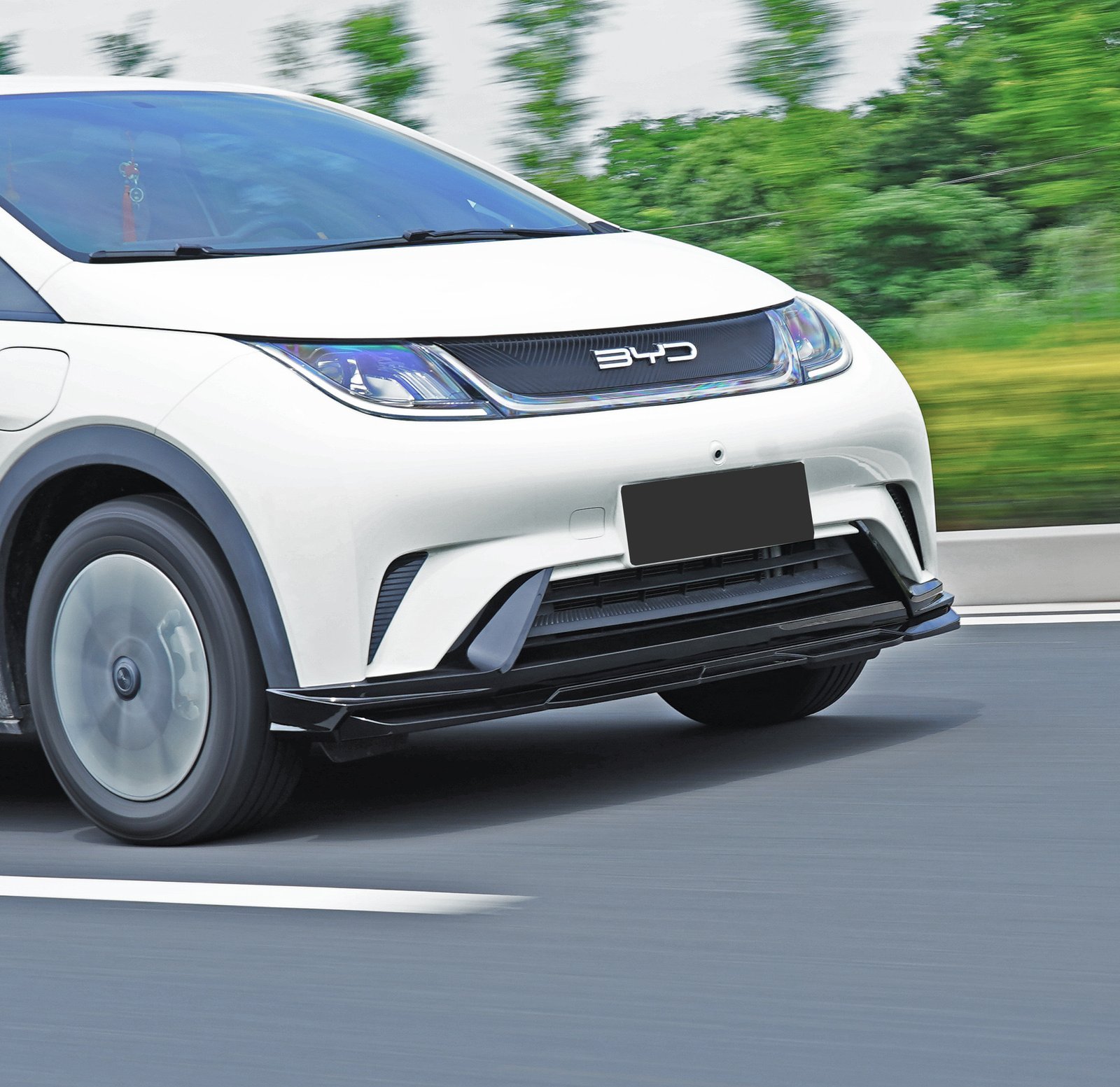 Marvix body kit for BYD Dolphin, front lip fitted to a white BYD Dolphin on the road