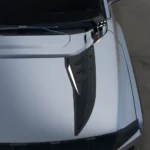 Close-up of a gloss black hood vent trim panel fitted on the BYD Shark 6 hood