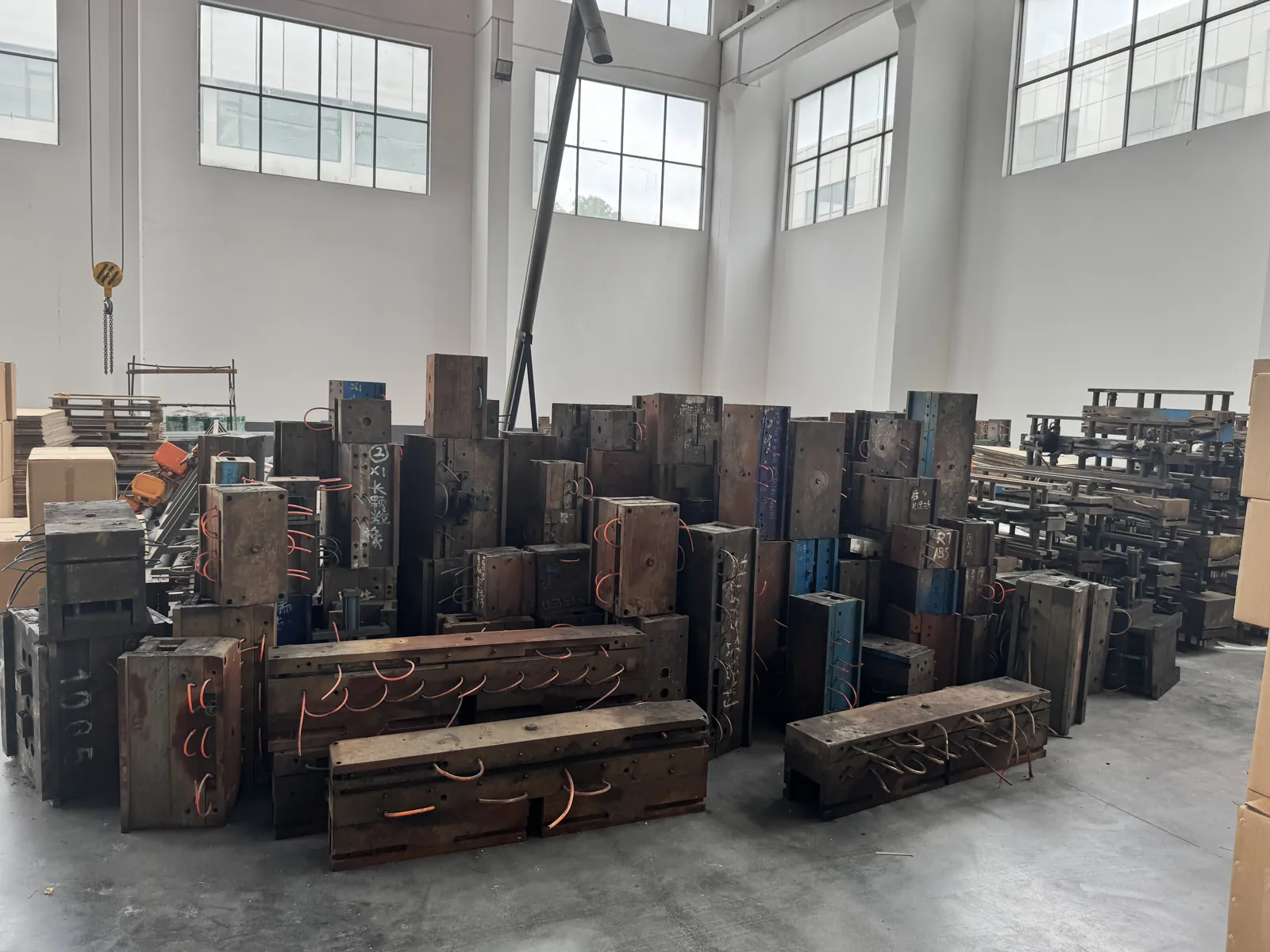 Rows of steel injection molds for BYD plastic exterior parts stored in a warehouse