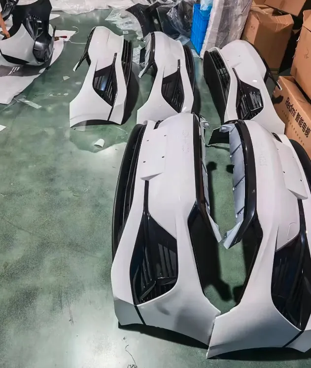 Aftermarket replacement front bumpers laid out for a pre-shipment check